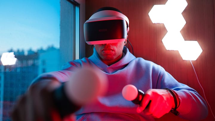 man in gray hoodie wearing a virtual reality headset